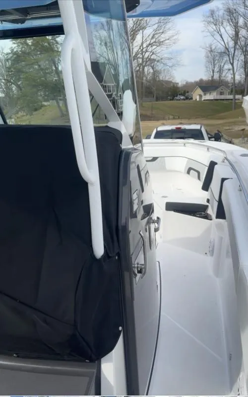 Slide: The Image of 2025 Blackfin 272 Center Console boat docked, showcasing sleek design and spacious deck. - 13