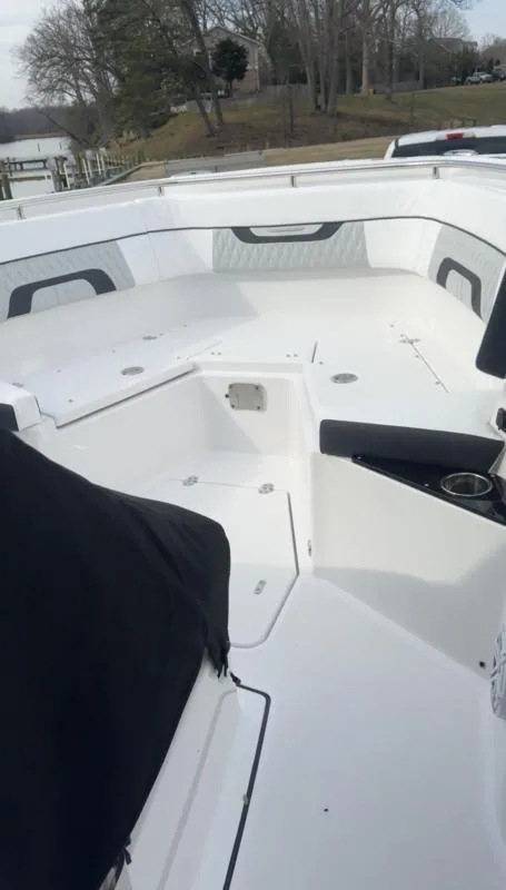 Slide: The Image of 2025 Blackfin 272 Center Console boat interior with white seating and cup holders. - 16