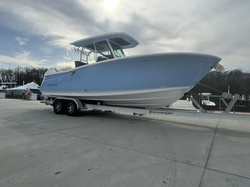 Slide: The Image of 2025 Blackfin 272 Center Console boat on trailer, parked outdoors under cloudy sky. - 5