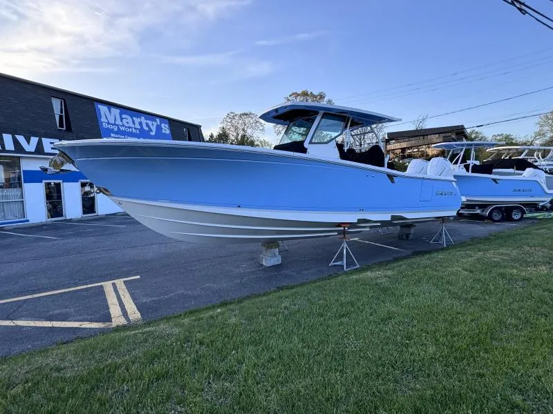 Slide: The Image of 2025 Blackfin 332 boat displayed outdoors near Marty's Bag Works. - 13