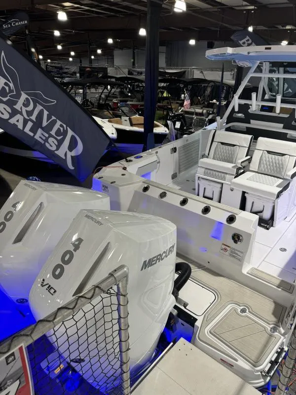 Slide: The Image of 2025 Blackfin 332 boat with dual Mercury 400 engines at a showroom display. - 4