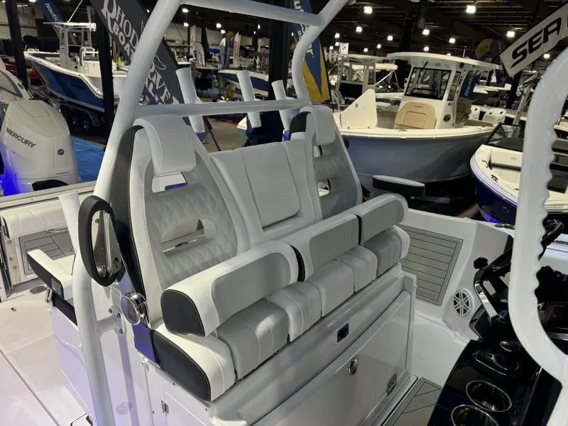 Slide: The Image of 2025 Blackfin 332 boat interior with luxurious seating at a boat show. - 8