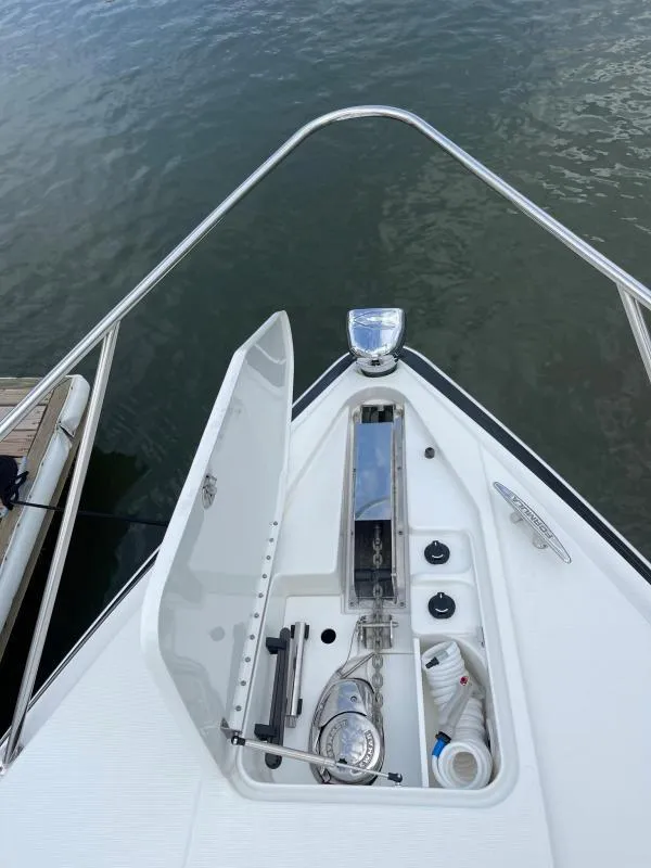 Slide: The Image of 2016 Formula Boats 37 PC bow with open anchor locker, docked on calm water. - 11
