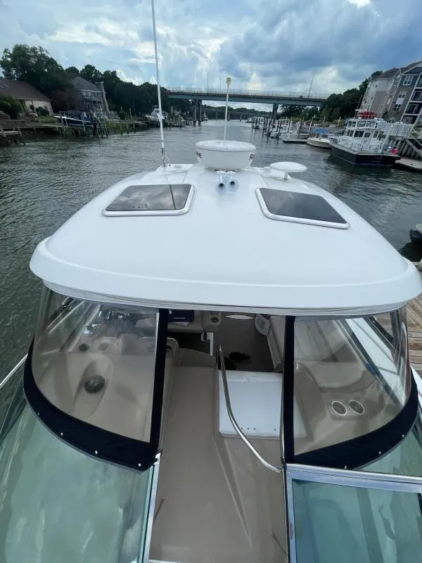 Slide: The Image of 2016 Formula Boats 37 PC docked on a calm river under cloudy skies. - 14
