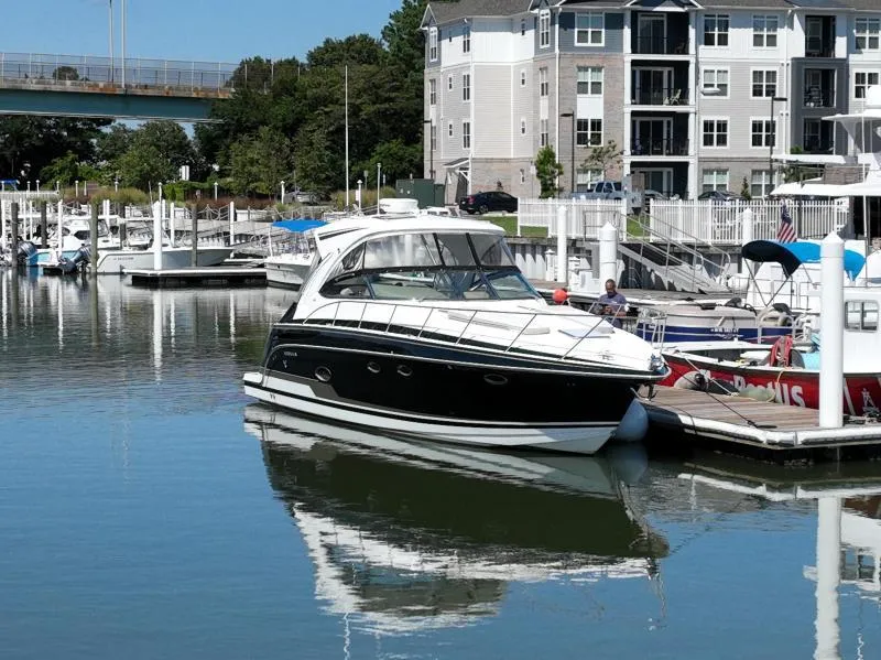 Slide: The Image of 2016 Formula Boats 37 PC docked in a marina with waterfront apartments. - 2