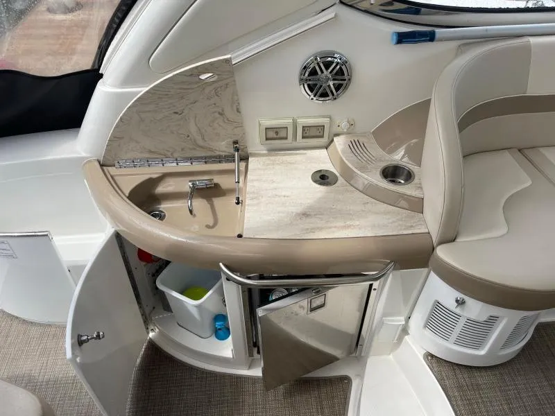 Slide: The Image of 2016 Formula Boats 37 PC interior with sink, storage, and seating area. - 20