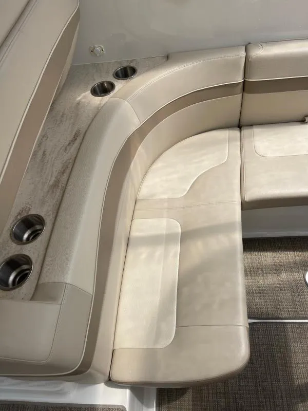 Slide: The Image of 2016 Formula Boats 37 PC interior seating with beige upholstery and cup holders. - 22