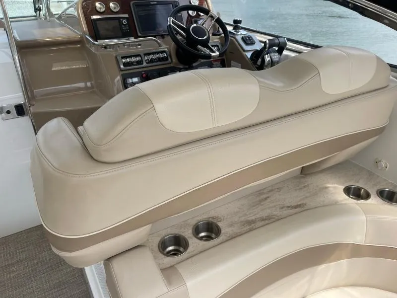 Slide: The Image of 2016 Formula Boats 37 PC cockpit with beige seating and control panel. - 23