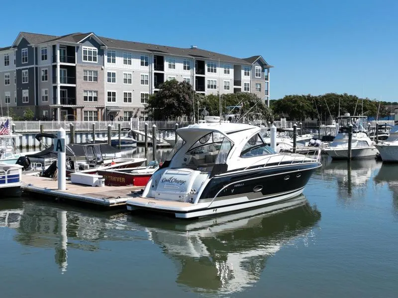 Slide: The Image of 2016 Formula Boats 37 PC docked at marina with waterfront apartments in background. - 4