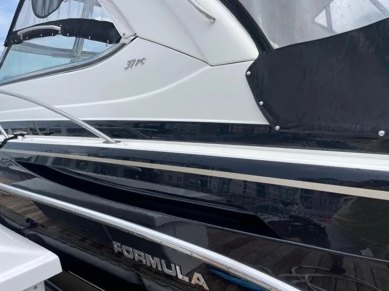 Slide: The Image of 2016 Formula Boats 37 PC, sleek black and white exterior, docked. - 7