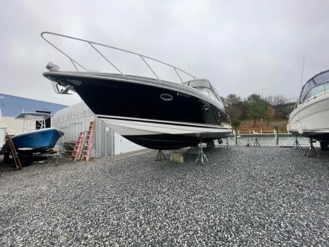 Slide: The Image of 2016 Formula Boats 37 PC on gravel lot, elevated for maintenance. - 8