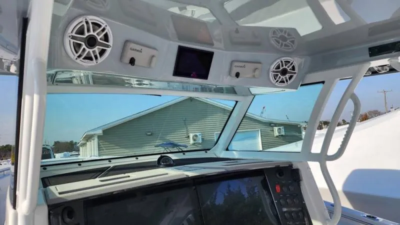 Slide: The Image of Interior view of a 2025 Blackfin 400 boat cockpit with modern controls and speakers. - 18