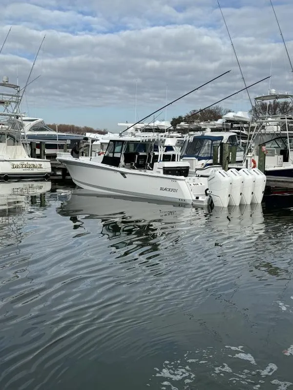 Slide: The Image of 2025 Blackfin 400 boat docked in marina, featuring multiple outboard engines. - 3