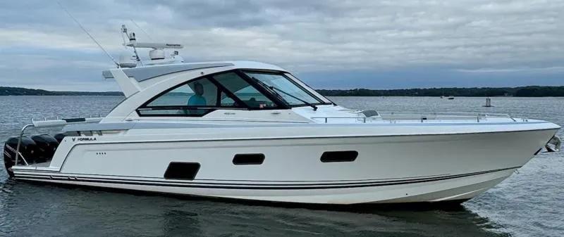 Slide: The Image of 2020 Formula 400 Super Sport Crossover boat on calm water, side view. - 1