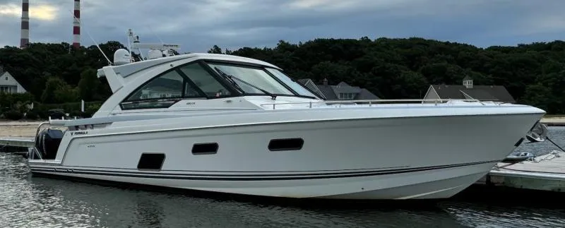 Slide: The Image of 2020 Formula 400 Super Sport Crossover yacht docked by waterfront homes. - 10