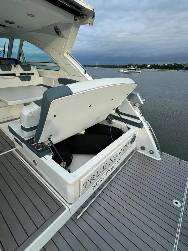 Slide: The Image of 2020 Formula 400 Super Sport Crossover yacht with open storage, docked by calm waters. - 11