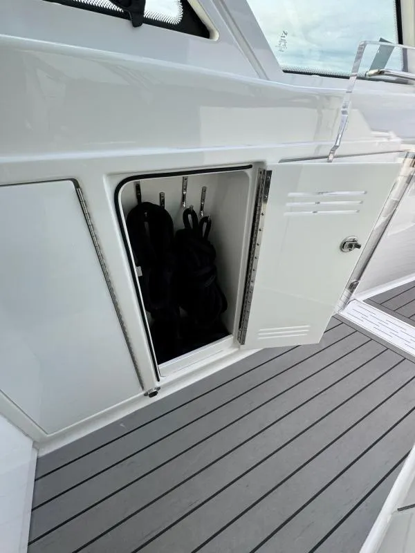 Slide: The Image of Open storage compartment on 2020 Formula 400 Super Sport Crossover boat deck. - 19