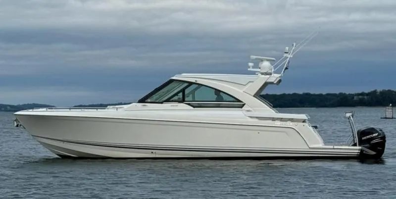 Slide: The Image of 2020 Formula 400 Super Sport Crossover boat on calm water, side view. - 2