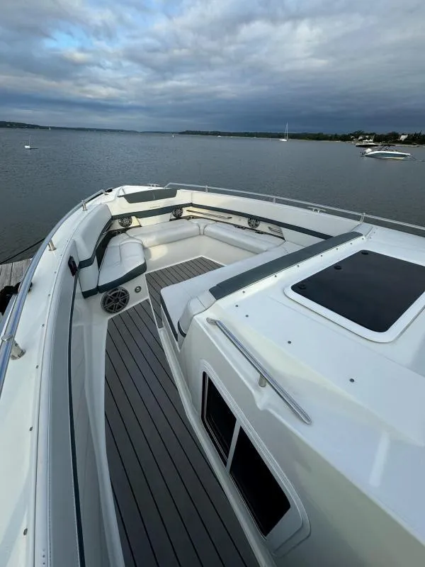 Slide: The Image of 2020 Formula 400 Super Sport Crossover boat on calm water, featuring spacious deck seating. - 20