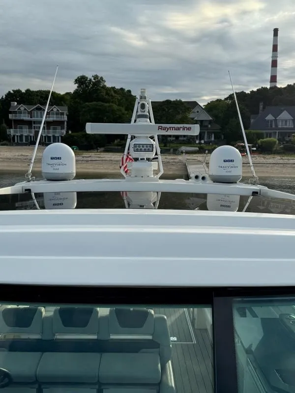 Slide: The Image of 2020 Formula 400 Super Sport Crossover yacht with Raymarine equipment, docked near waterfront homes. - 22