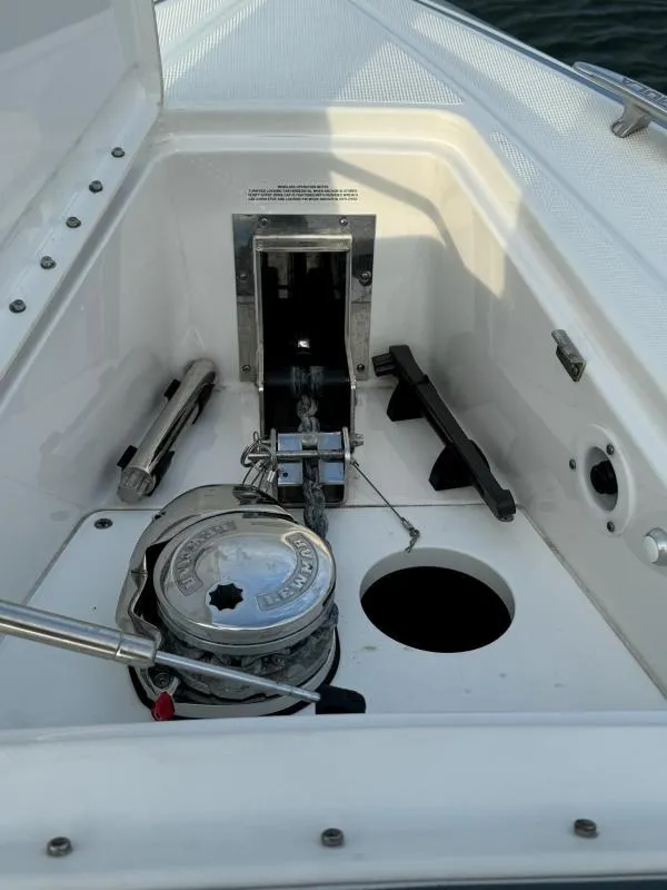 Slide: The Image of Anchor compartment of 2020 Formula 400 Super Sport Crossover boat, featuring winch and storage. - 23