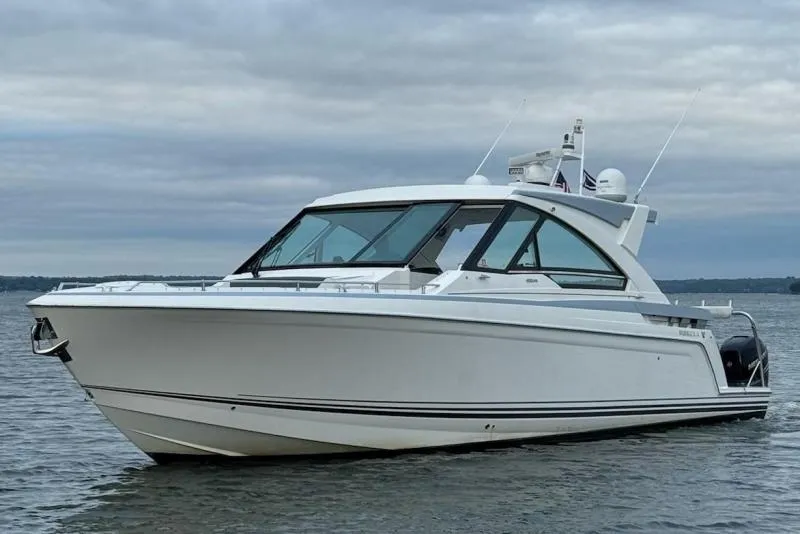 Slide: The Image of 2020 Formula 400 Super Sport Crossover boat on calm water under cloudy sky. - 3