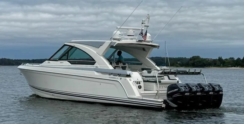 Slide: The Image of 2020 Formula 400 Super Sport Crossover boat on water with four Mercury engines. - 5