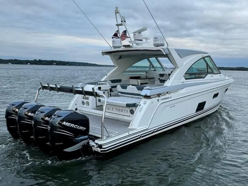 Slide: The Image of 2020 Formula 400 Super Sport Crossover boat cruising on a calm lake. - 6