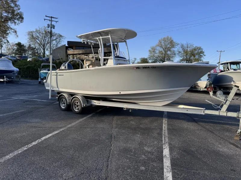 Slide: The Image of 2023 Sportsman 231 Heritage boat on trailer in parking lot, clear sky background. - 1