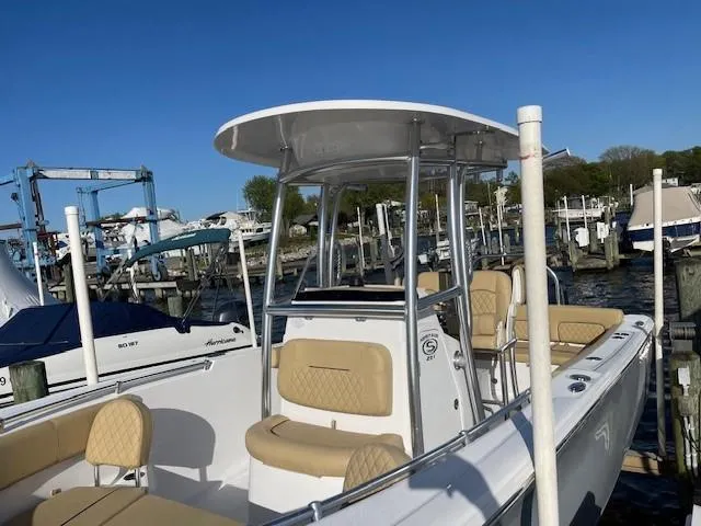 Slide: The Image of 2023 Sportsman 231 Heritage boat docked at marina under clear blue sky. - 10