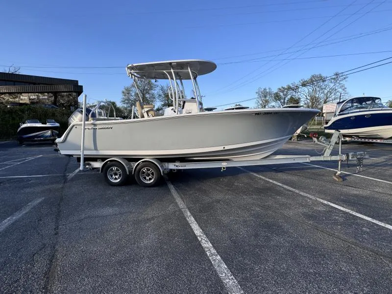 Slide: The Image of 2023 Sportsman 231 Heritage boat on trailer in parking lot, side view. - 12