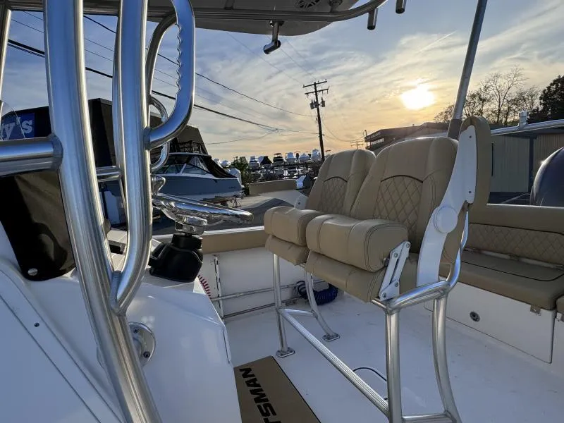 Slide: The Image of 2023 Sportsman 231 Heritage boat interior with beige seating at sunset. - 18