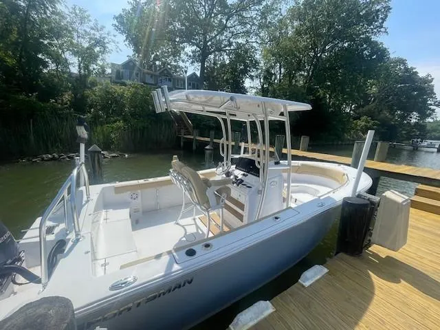 Slide: The Image of 2023 Sportsman 231 Heritage boat docked by a scenic waterfront. - 6