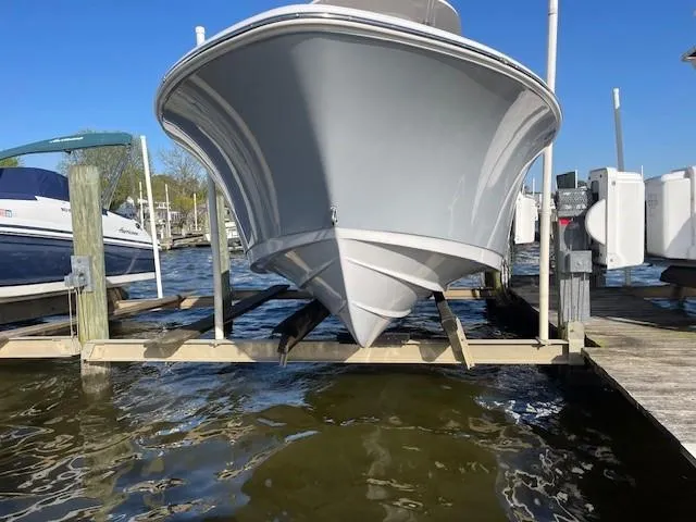 Slide: The Image of 2023 Sportsman 231 Heritage boat docked on a sunny day. - 7