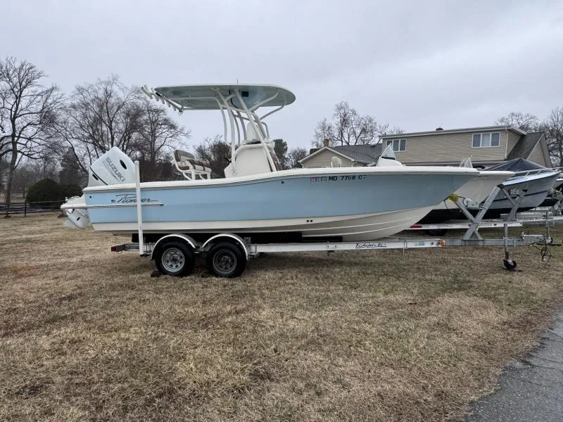 Slide: The Image of 2021 Pioneer 220 Bay Sport boat on trailer, parked on grass. - 1