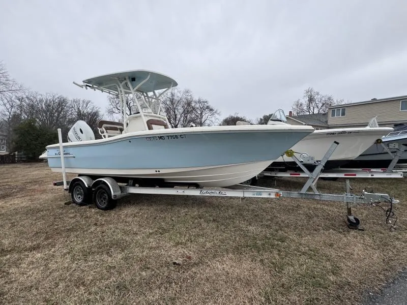 Slide: The Image of 2021 Pioneer 220 Bay Sport boat on trailer, parked on grass. - 4
