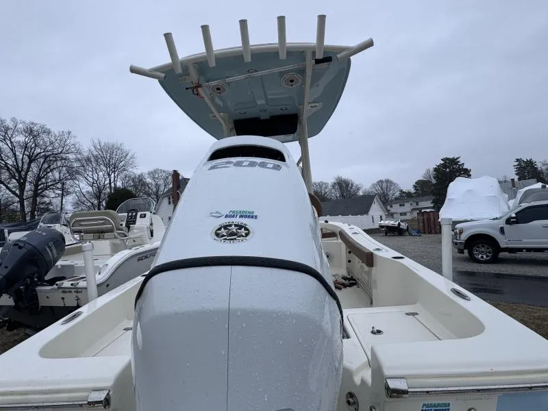 Slide: The Image of 2021 Pioneer 220 Bay Sport boat with outboard motor, parked outdoors on a cloudy day. - 7