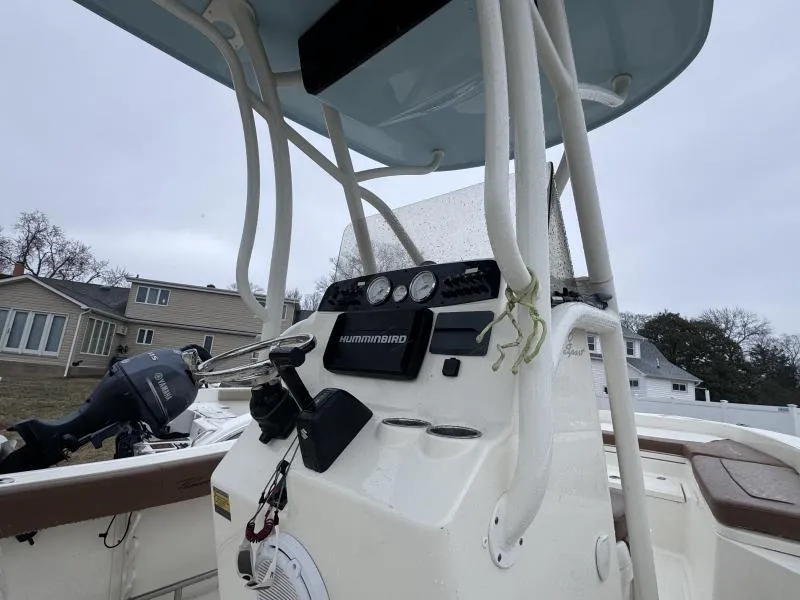 Slide: The Image of 2021 Pioneer 220 Bay Sport boat console with Humminbird electronics, overcast sky background. - 9