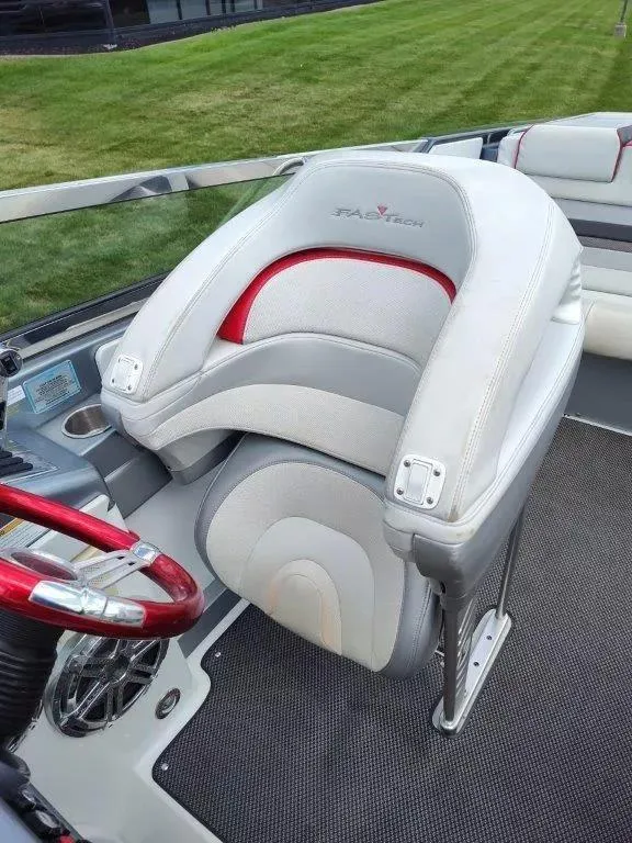 Slide: The Image of 2015 Formula 382 FASTech boat interior with plush seating and red-accented steering wheel. - 10