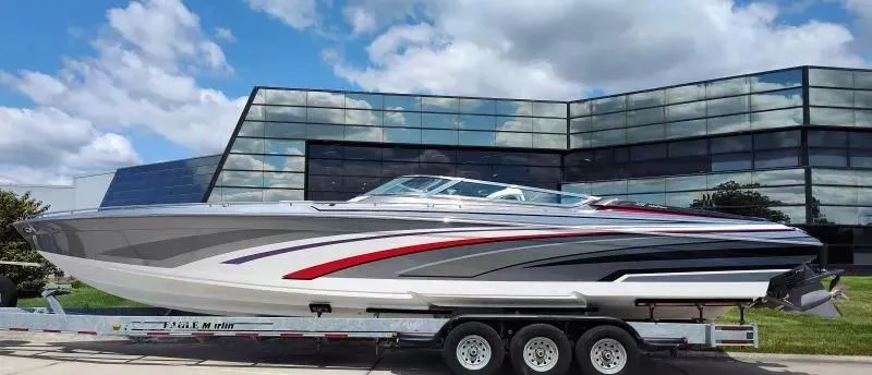 Slide: The Image of 2015 Formula 382 FASTech boat on trailer, sleek design, parked near modern glass building. - 2
