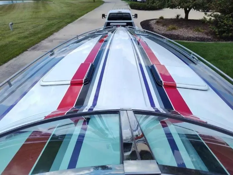 Slide: The Image of 2015 Formula 382 FASTech boat with red, white, and blue stripes on a trailer. - 22