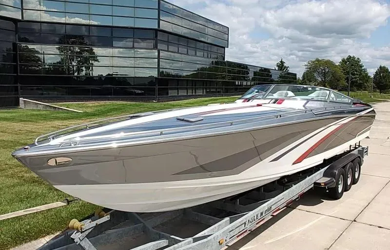 Slide: The Image of 2015 Formula 382 FASTech boat on trailer, parked near modern glass building. - 24