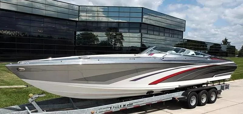 Slide: The Image of 2015 Formula 382 FASTech boat on trailer, sleek design, parked outside modern glass building. - 25