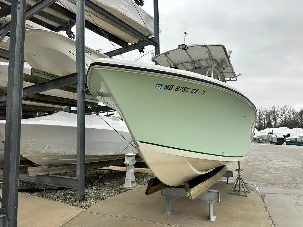 Slide: The Image of 2006 Sailfish 2360 boat stored on a rack in a marina. - 1