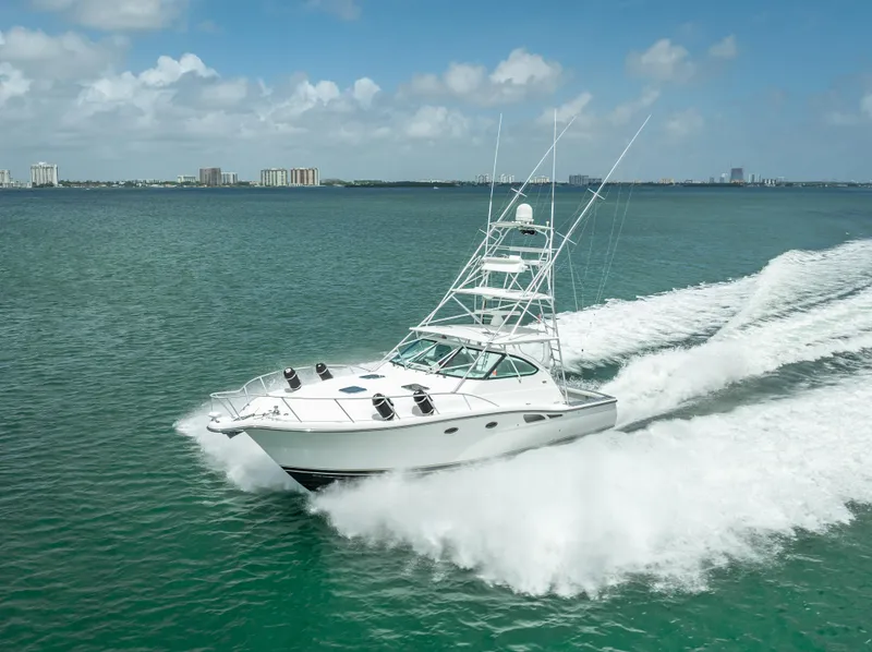 The Image of 2006 Tiara Yachts 4200 Open cruising on open water, creating a dynamic wake. - 0