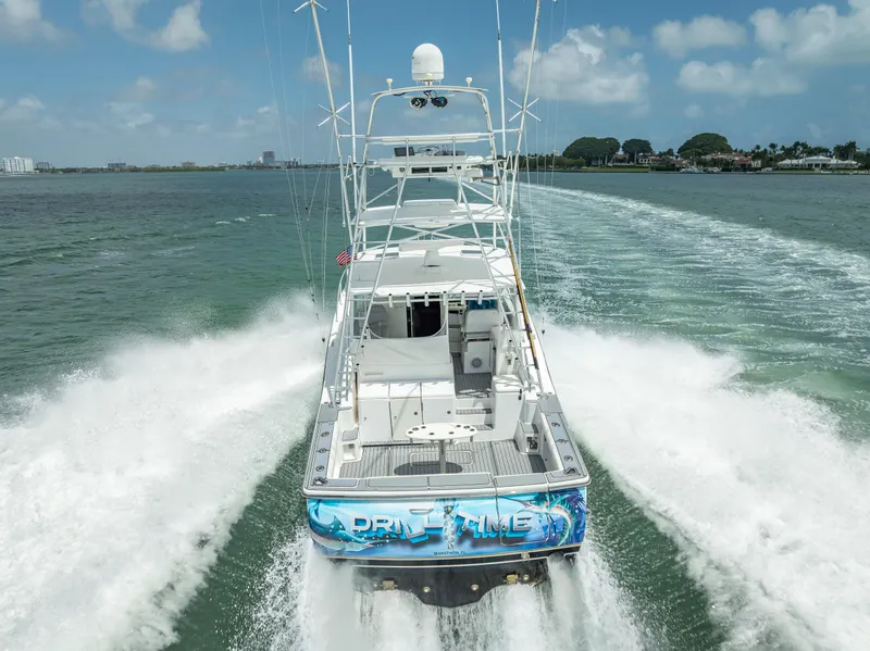 Slide: The Image of 2006 Tiara Yachts 4200 Open cruising on water, rear view, creating waves. - 12