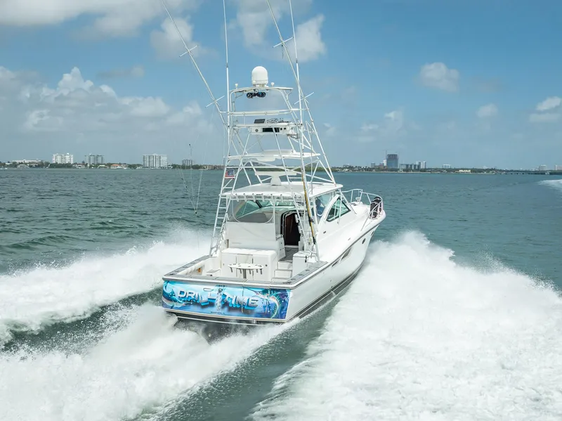 Slide: The Image of 2006 Tiara Yachts 4200 Open cruising on open water, rear view. - 13