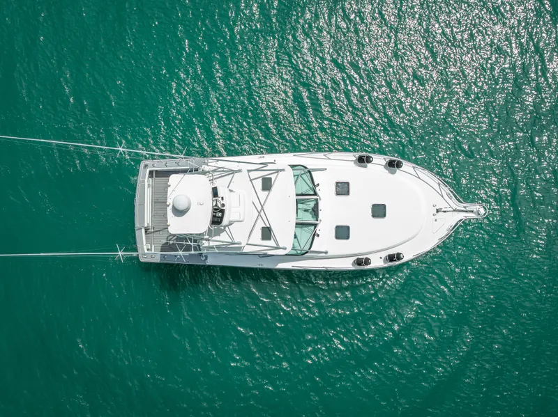 Slide: The Image of Aerial view of 2006 Tiara Yachts 4200 Open on turquoise water. - 15