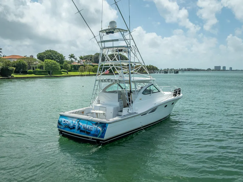 Slide: The Image of 2006 Tiara Yachts 4200 Open on calm water, featuring a sleek design and fishing tower. - 25