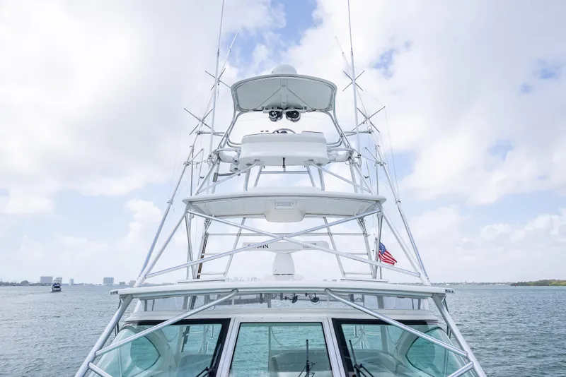 Slide: The Image of 2006 Tiara Yachts 4200 Open on water, showcasing tower and helm against cloudy sky. - 30